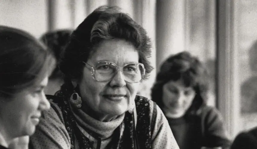 A woman with glasses and a scarf on.