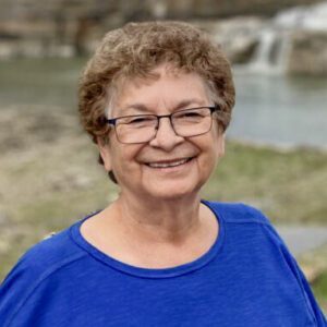 Smiling older woman wearing glasses outdoors
