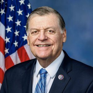 Smiling man in suit with American flag